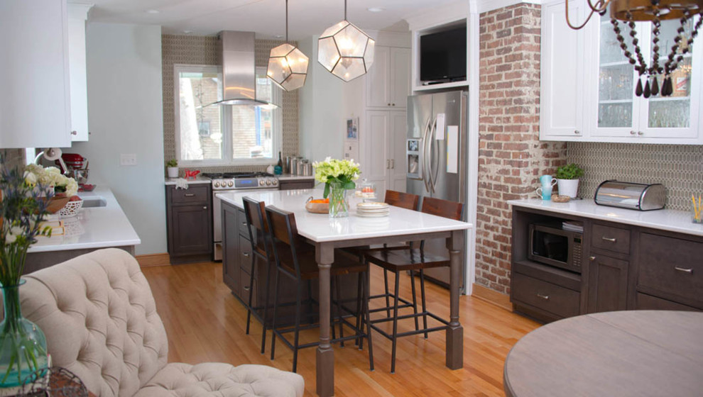 Inspiration for a mid-sized transitional l-shaped light wood floor and beige floor enclosed kitchen remodel with an undermount sink, glass-front cabinets, white cabinets, quartz countertops, gray backsplash, porcelain backsplash, stainless steel appliances and an island
