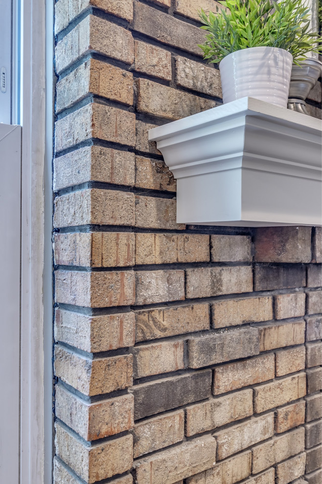 Eat-in kitchen - mid-sized transitional u-shaped brown floor eat-in kitchen idea in St Louis with white cabinets, granite countertops, white backsplash, subway tile backsplash, stainless steel appliances, an island and multicolored countertops