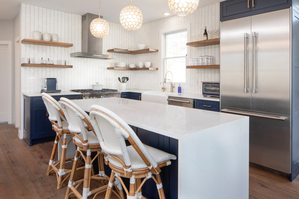 Photo of a medium sized coastal l-shaped kitchen/diner in New York with shaker cabinets, blue cabinets, engineered stone countertops, an island and white worktops.