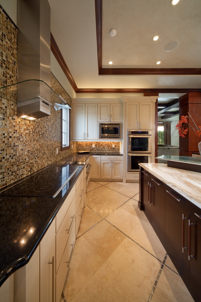 Eat-in kitchen - large transitional u-shaped travertine floor and brown floor eat-in kitchen idea in Orlando with flat-panel cabinets, white cabinets, granite countertops, beige backsplash, mosaic tile backsplash, stainless steel appliances, an island and a double-bowl sink