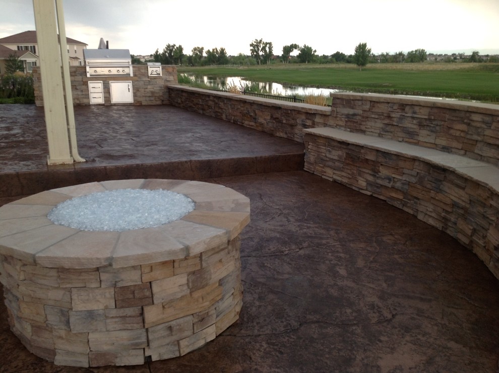 Large transitional backyard stamped concrete patio kitchen photo in Denver with no cover