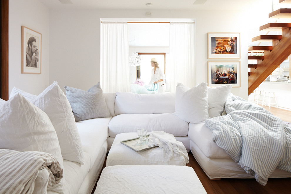 Example of a small minimalist open concept medium tone wood floor family room design in Los Angeles with white walls