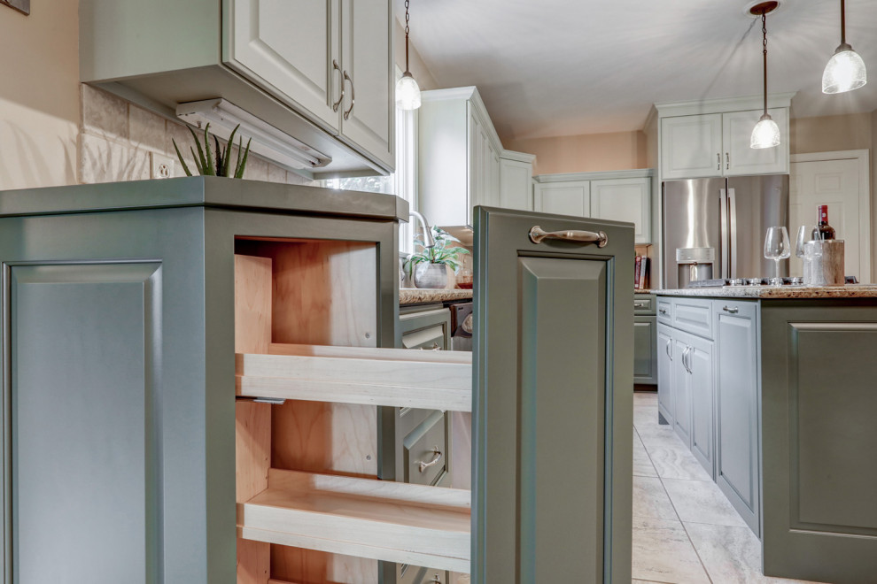 Mid-sized transitional l-shaped ceramic tile and beige floor eat-in kitchen photo with a double-bowl sink, raised-panel cabinets, green cabinets, granite countertops, beige backsplash, ceramic backsplash, stainless steel appliances, an island and beige countertops