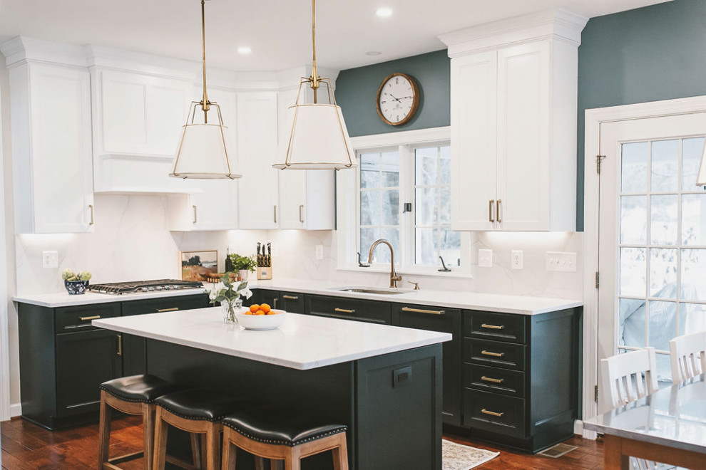 Kitchen - transitional l-shaped dark wood floor and brown floor kitchen idea in Baltimore with an undermount sink, shaker cabinets, black cabinets, white backsplash, stone slab backsplash, paneled appliances, an island and white countertops