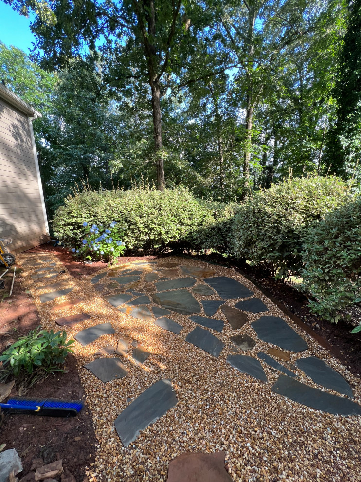 Geometrischer, Kleiner Garten im Sommer mit direkter Sonneneinstrahlung, Natursteinplatten und Steinzaun in Atlanta
