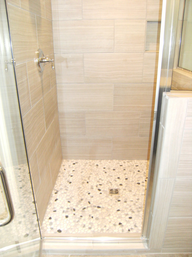 This is an example of a mid-sized traditional master bathroom in Other with a corner shower, multi-coloured tile, stone tile, blue walls and pebble tile floors.