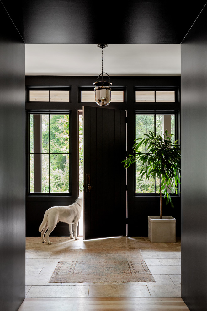 Single front door - mid-sized cottage travertine floor, beige floor and wood wall single front door idea in DC Metro with black walls and a black front door