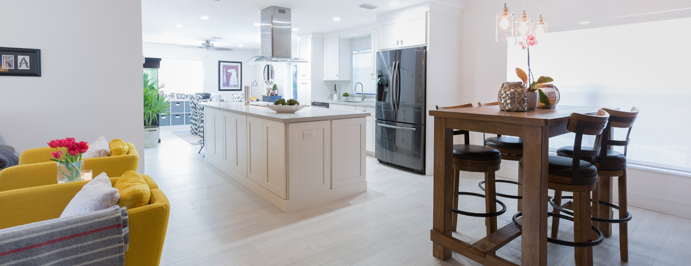 Small transitional single-wall porcelain tile open concept kitchen photo in Miami with an undermount sink, shaker cabinets, white cabinets, quartz countertops, white backsplash and an island