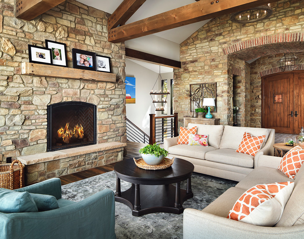 Inspiration for a large country formal open concept living room in Other with dark hardwood floors, a standard fireplace, a stone fireplace surround and no tv.