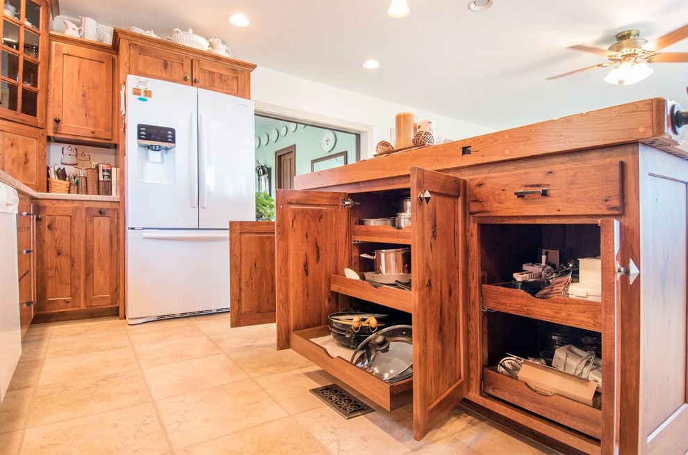 Inspiration for a mid-sized country u-shaped eat-in kitchen in Cincinnati with a drop-in sink, recessed-panel cabinets, medium wood cabinets, wood benchtops, white appliances, laminate floors, with island and brown benchtop.