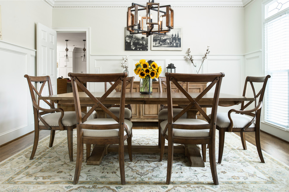 Photo of a mid-sized country separate dining room in Atlanta with white walls, dark hardwood floors, brown floor and no fireplace.