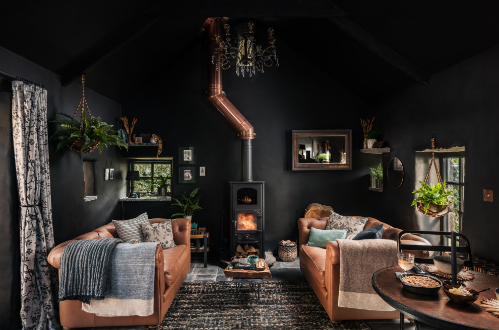 Photo of a mid-sized country open concept living room in Cornwall with black walls.
