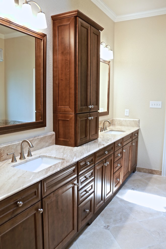 Mid-sized transitional master bathroom in Dallas with an undermount sink, recessed-panel cabinets, dark wood cabinets, granite benchtops, a drop-in tub, a corner shower, beige tile, stone slab, beige walls and travertine floors.