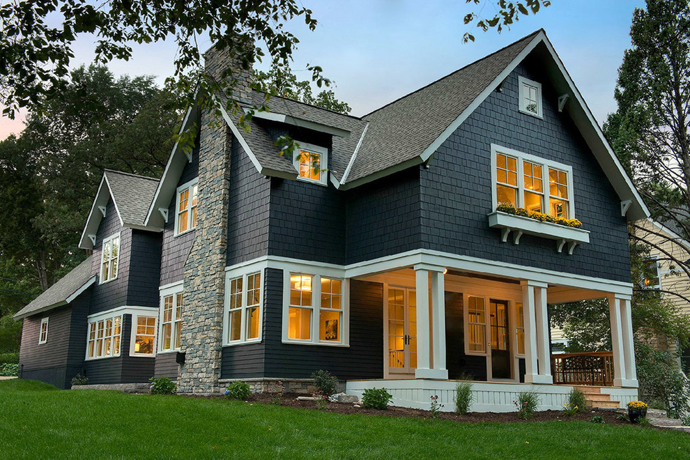 This is an example of a large transitional two-storey black exterior in Minneapolis with wood siding and a hip roof.