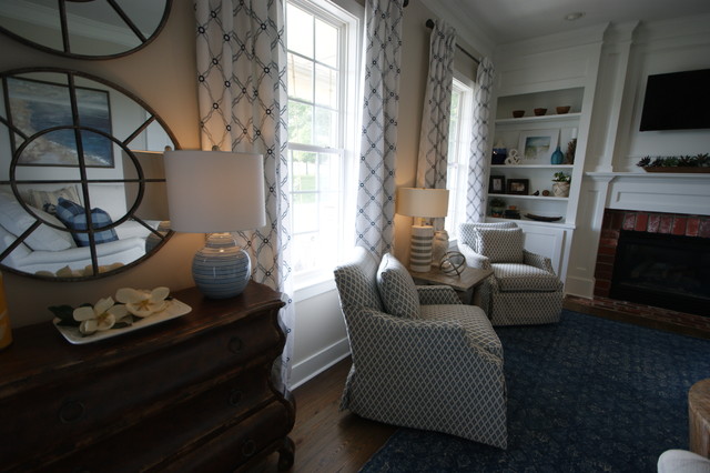 Family room - mid-sized transitional medium tone wood floor family room idea in Atlanta with gray walls, a standard fireplace, a brick fireplace and a wall-mounted tv