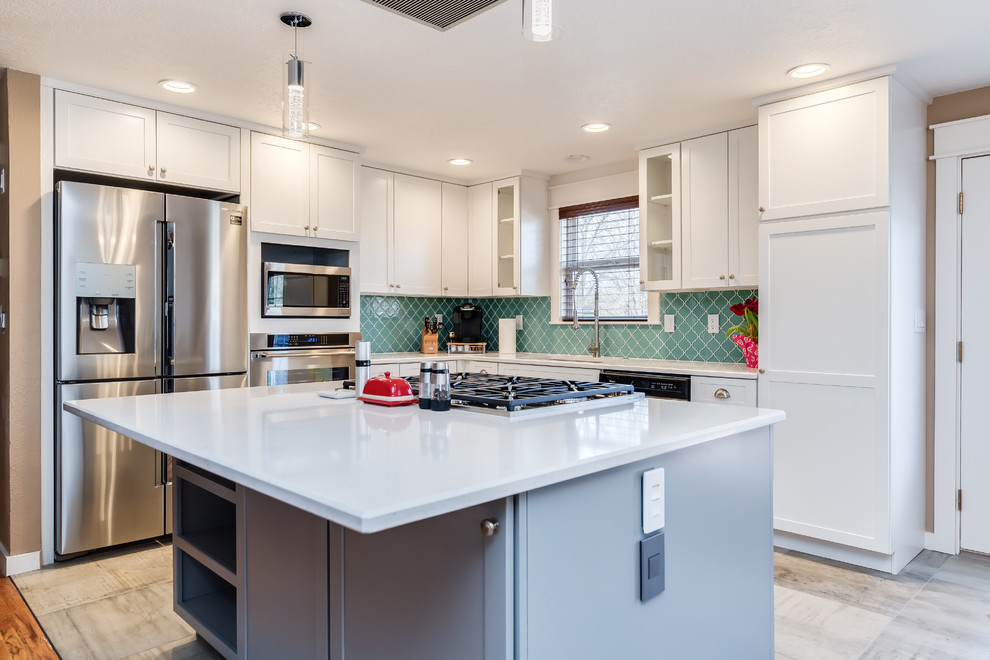 Inspiration for a small transitional l-shaped porcelain tile and gray floor eat-in kitchen remodel in Boise with a single-bowl sink, shaker cabinets, white cabinets, quartz countertops, blue backsplash, glass tile backsplash, stainless steel appliances and an island