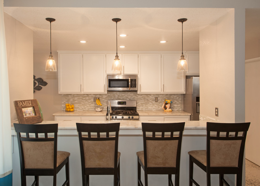 Kitchen - mid-sized transitional kitchen idea in Sacramento with flat-panel cabinets, white cabinets, granite countertops and glass tile backsplash