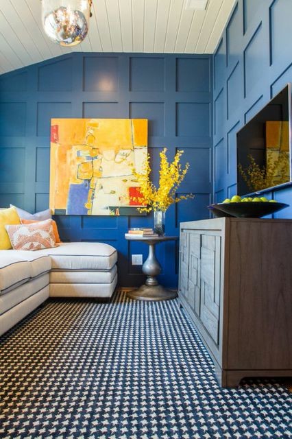 Inspiration for an eclectic family room in Nashville with blue walls, medium hardwood floors and a wall-mounted tv.