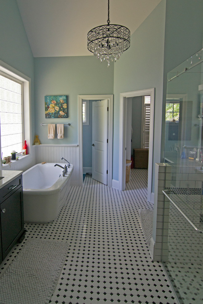 Inspiration for a mid-sized contemporary master bathroom in Other with shaker cabinets, black cabinets, a curbless shower, a one-piece toilet, blue walls, mosaic tile floors, an undermount sink, granite benchtops, white floor and a sliding shower screen.