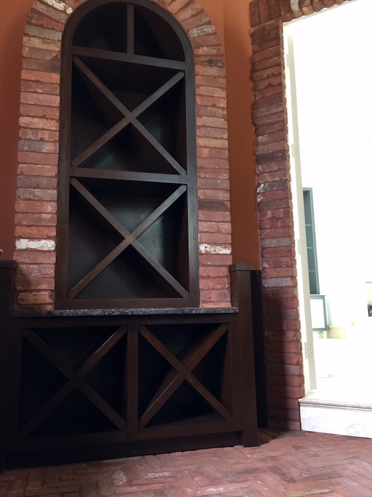 Wine cellar - mid-sized rustic brick floor wine cellar idea with diamond bins