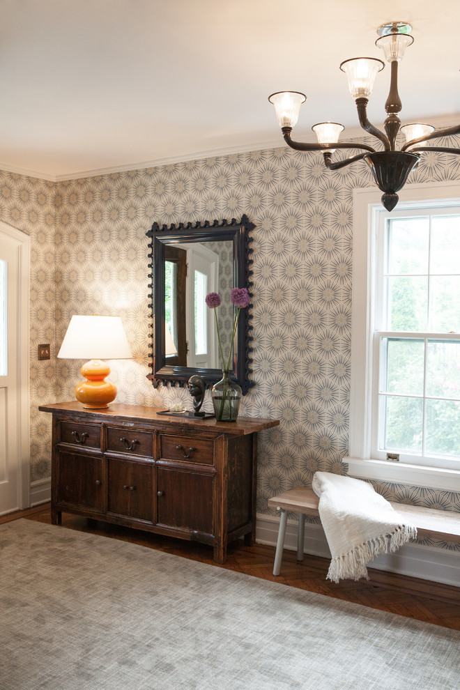 Large transitional medium tone wood floor front door photo in New York with multicolored walls and a white front door
