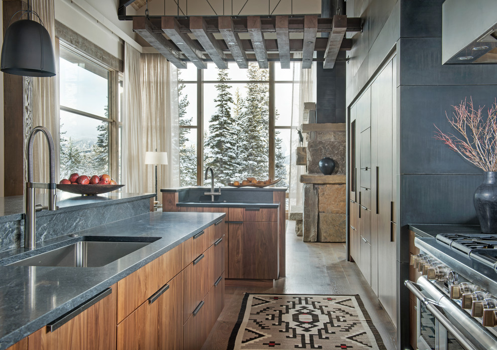 Inspiration for a rustic galley dark wood floor and brown floor open concept kitchen remodel with an undermount sink, flat-panel cabinets, medium tone wood cabinets and an island
