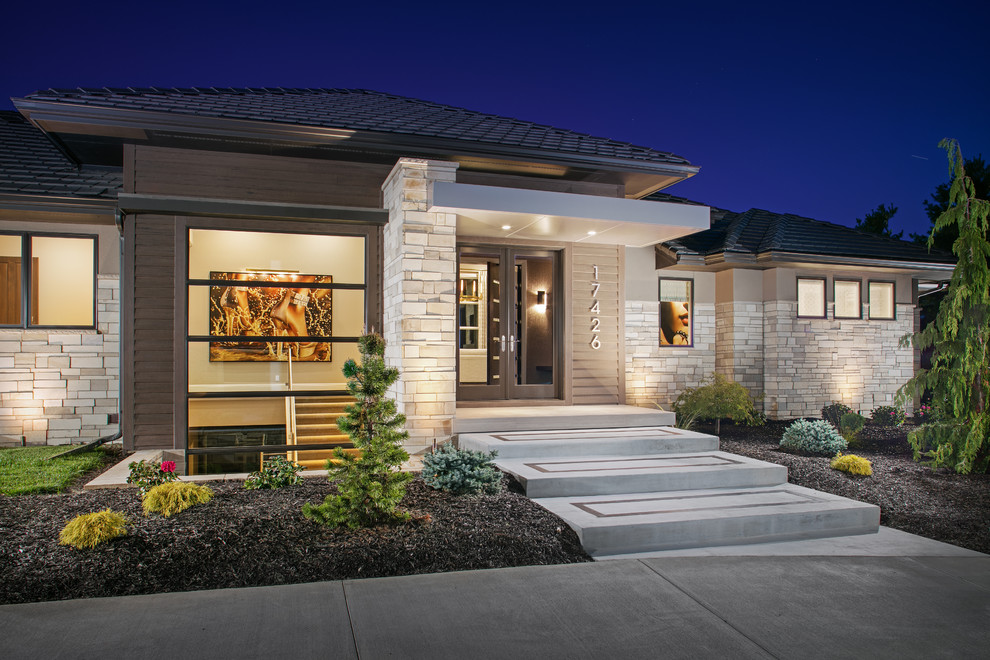 Inspiration for a mid-sized transitional beige one-story mixed siding house exterior remodel in Omaha with a hip roof and a shingle roof