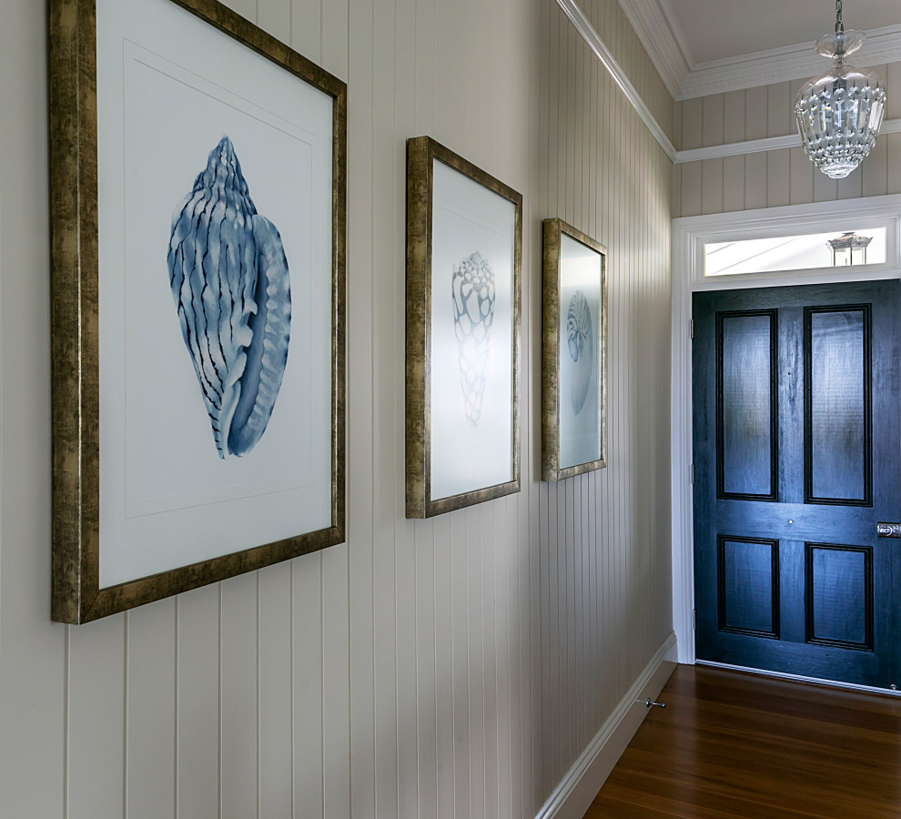 Inspiration for a mid-sized eclectic front door in Brisbane with white walls, light hardwood floors, a single front door, a blue front door and orange floor.