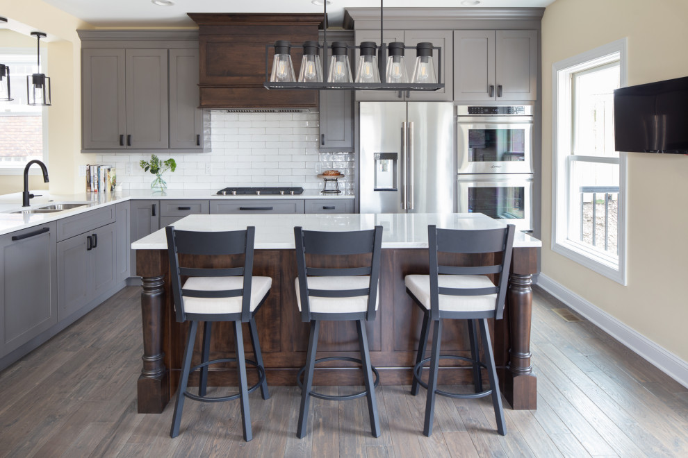Kitchen - kitchen idea with shaker cabinets, quartz countertops, white backsplash, subway tile backsplash and stainless steel appliances