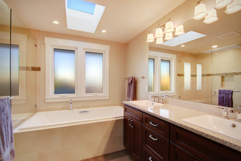 Photo of a small transitional master bathroom in Seattle with shaker cabinets, a drop-in tub, a double shower, beige tile, porcelain tile, beige walls, porcelain floors, a drop-in sink, granite benchtops and medium wood cabinets.