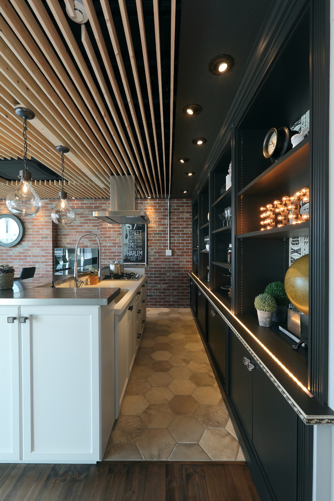 Photo of an industrial single-wall eat-in kitchen in Nagoya with an undermount sink, white cabinets, solid surface benchtops, terra-cotta floors and multi-coloured floor.