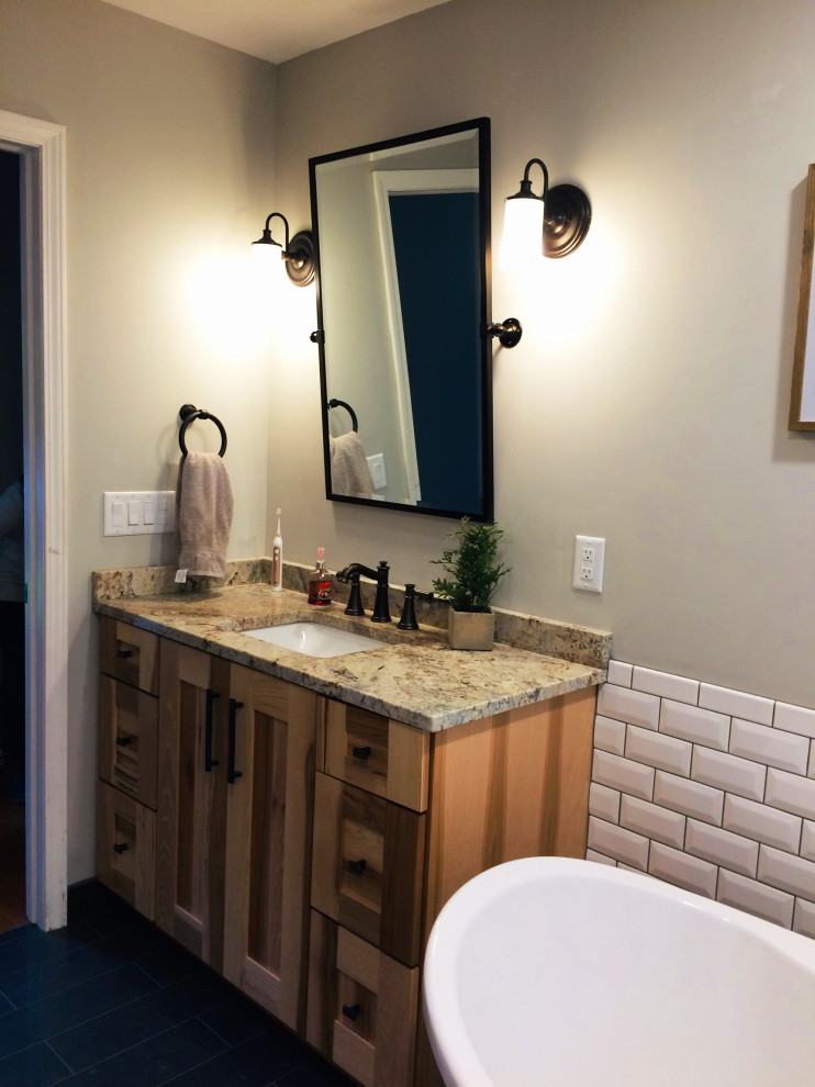 Example of a small mountain style white tile and subway tile ceramic tile, blue floor and single-sink freestanding bathtub design with shaker cabinets, medium tone wood cabinets, granite countertops and beige countertops