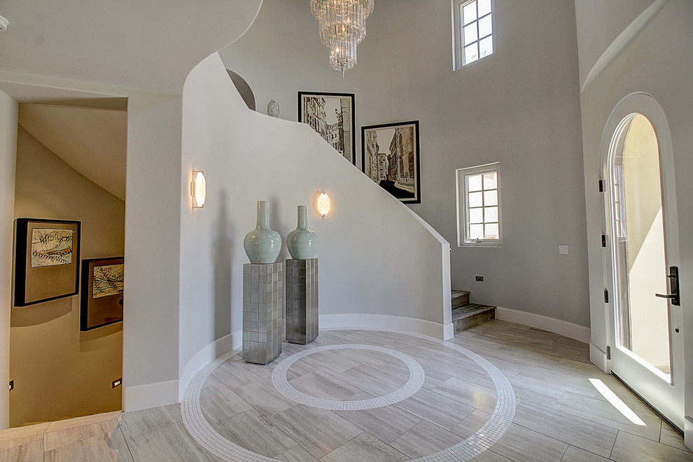 Photo of a foyer in San Francisco with grey walls, light hardwood floors and a pivot front door.
