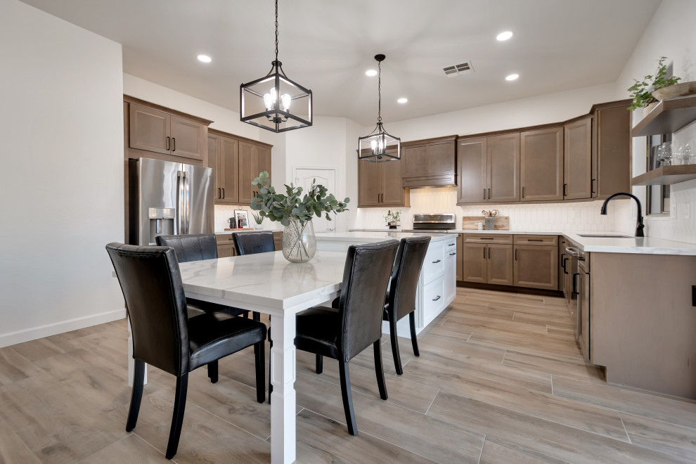 Eat-in kitchen - mid-sized transitional u-shaped ceramic tile and brown floor eat-in kitchen idea in Phoenix with beaded inset cabinets, brown cabinets, quartzite countertops, white backsplash, ceramic backsplash, an island and white countertops