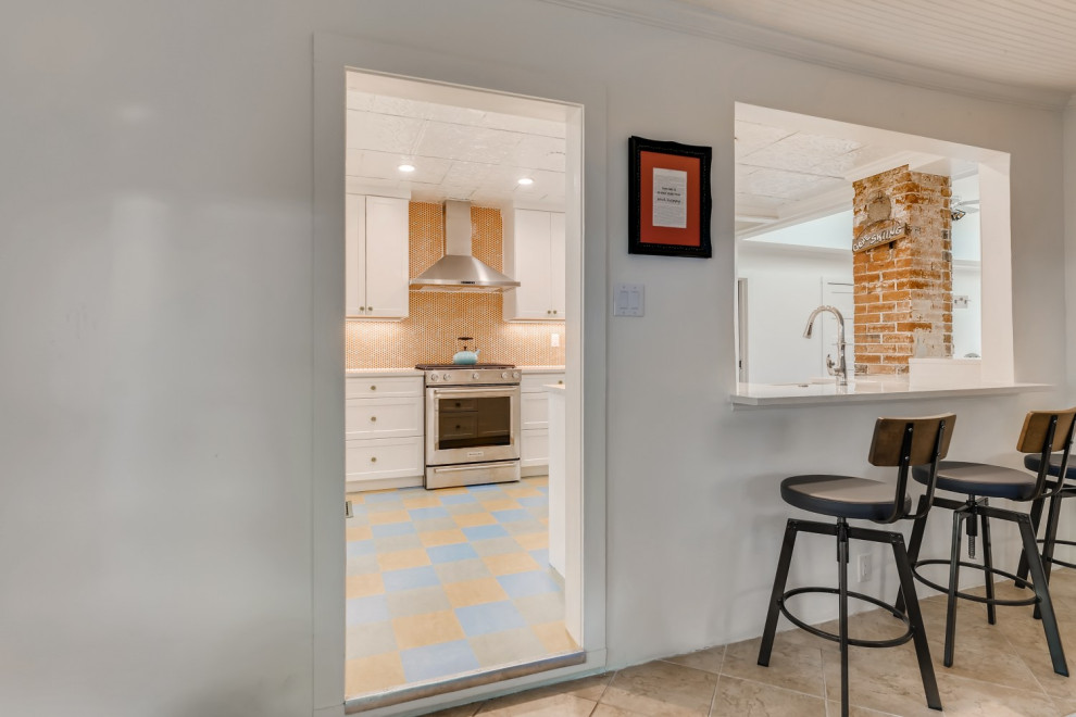 Inspiration for a small galley separate kitchen in Denver with a farmhouse sink, shaker cabinets, white cabinets, quartz benchtops, orange splashback, mosaic tile splashback, stainless steel appliances, linoleum floors, no island, blue floor, white benchtop and recessed.