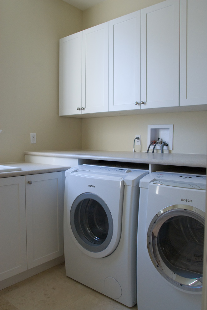 Small transitional l-shaped ceramic tile laundry closet photo in Toronto with an integrated sink, white cabinets, laminate countertops, beige walls, a side-by-side washer/dryer and shaker cabinets