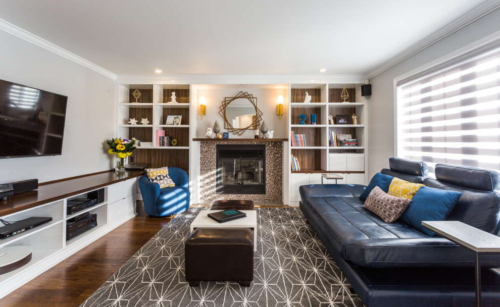 Example of a mid-sized trendy enclosed medium tone wood floor and brown floor family room design in Montreal with a music area, gray walls, a standard fireplace, a tile fireplace and a wall-mounted tv