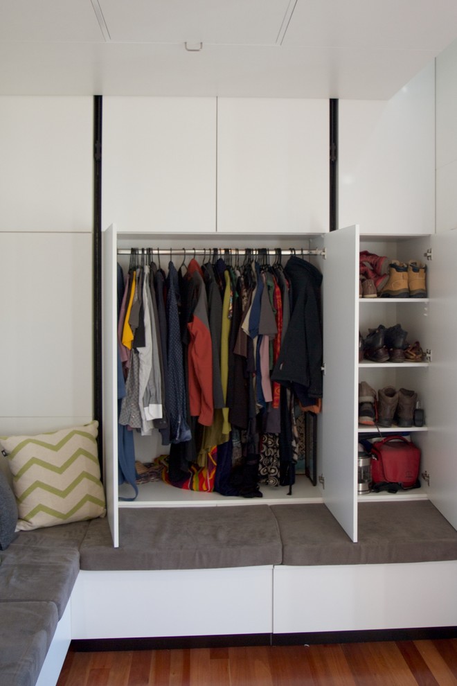 Small contemporary storage and wardrobe in Brisbane with dark hardwood floors.