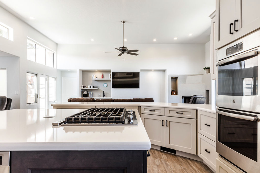 Example of a large transitional u-shaped vinyl floor and gray floor eat-in kitchen design with an undermount sink, shaker cabinets, gray cabinets, quartzite countertops, green backsplash, subway tile backsplash, stainless steel appliances, an island and white countertops