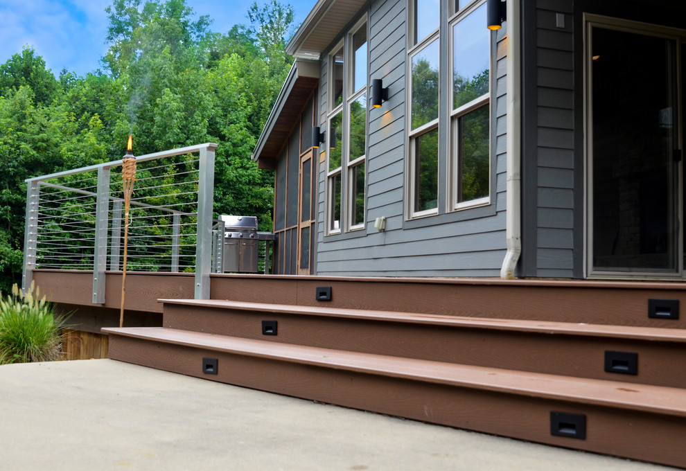 Example of a mid-sized transitional side yard patio design in Indianapolis with decking and no cover