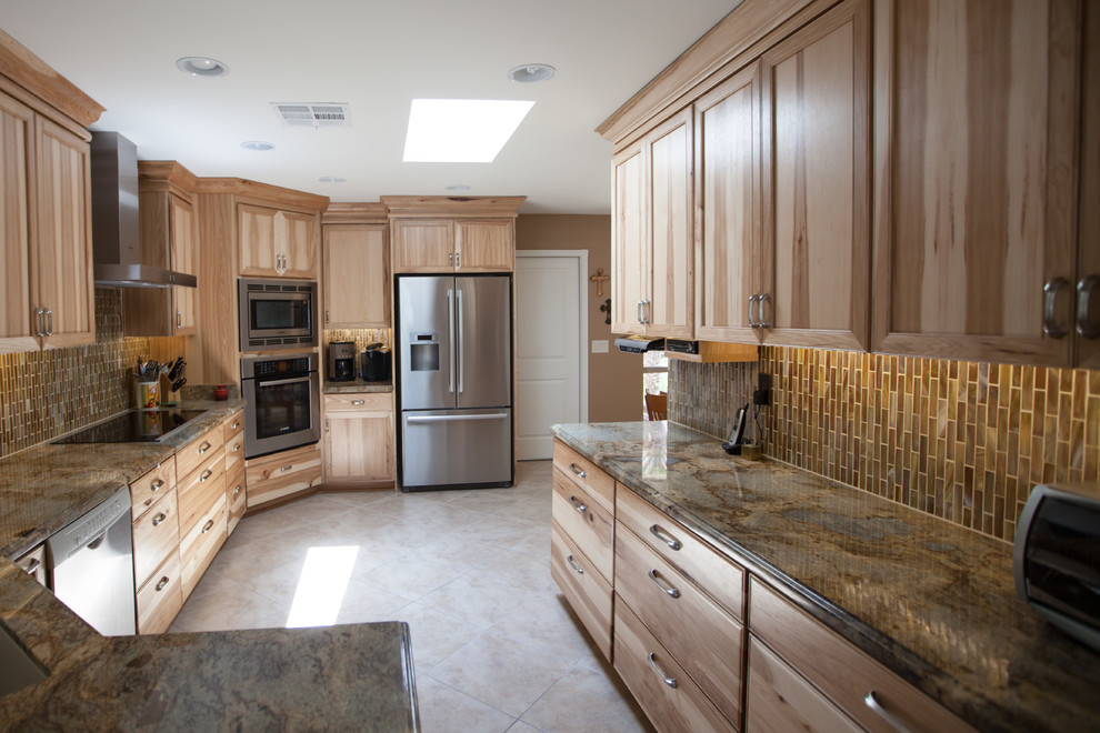 Inspiration for a large transitional galley ceramic tile enclosed kitchen remodel in Phoenix with an undermount sink, recessed-panel cabinets, light wood cabinets, granite countertops, brown backsplash, glass tile backsplash and stainless steel appliances