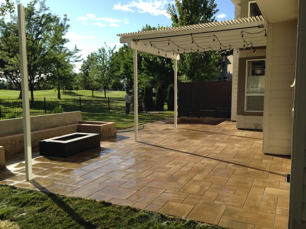 Photo of a mid-sized transitional backyard full sun garden for summer in Boise with a fire feature and concrete pavers.