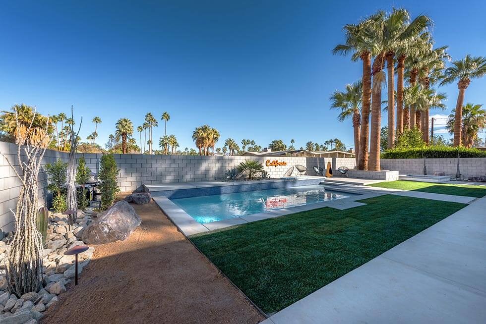Mid-sized transitional backyard concrete and rectangular hot tub photo in Los Angeles