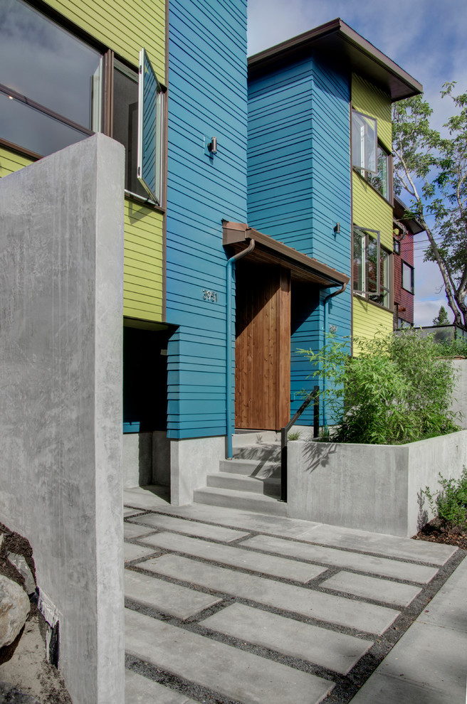 Inspiration for a modern three-storey blue exterior in Portland with concrete fiberboard siding.