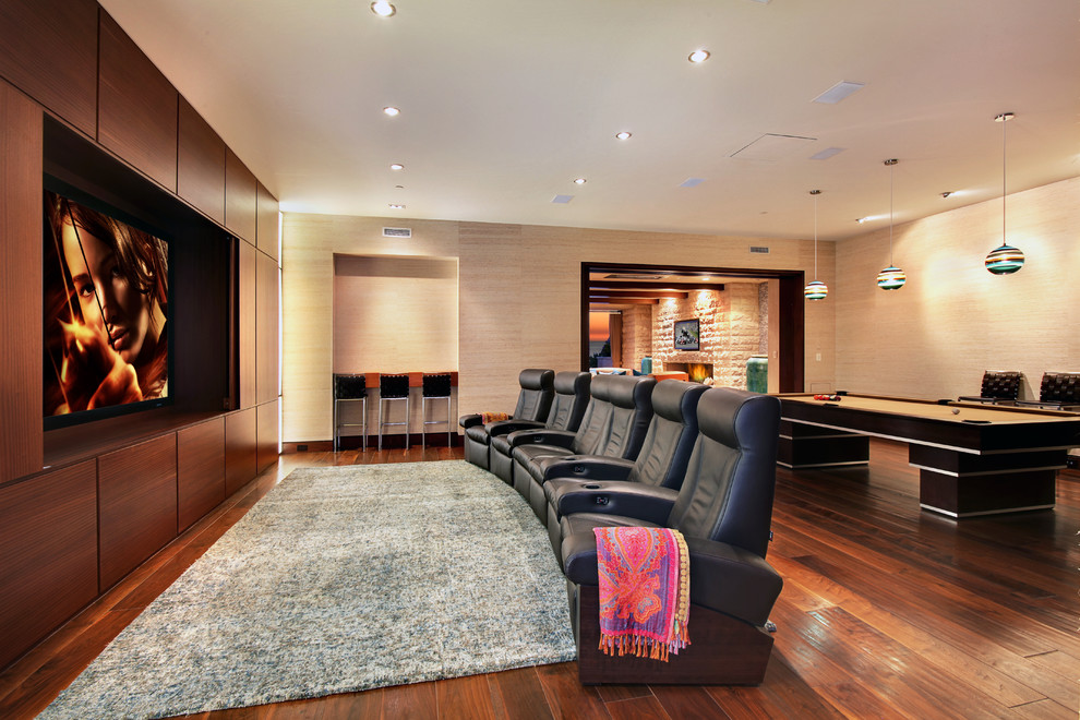 Inspiration for a contemporary home theatre in Orange County with brown floor.