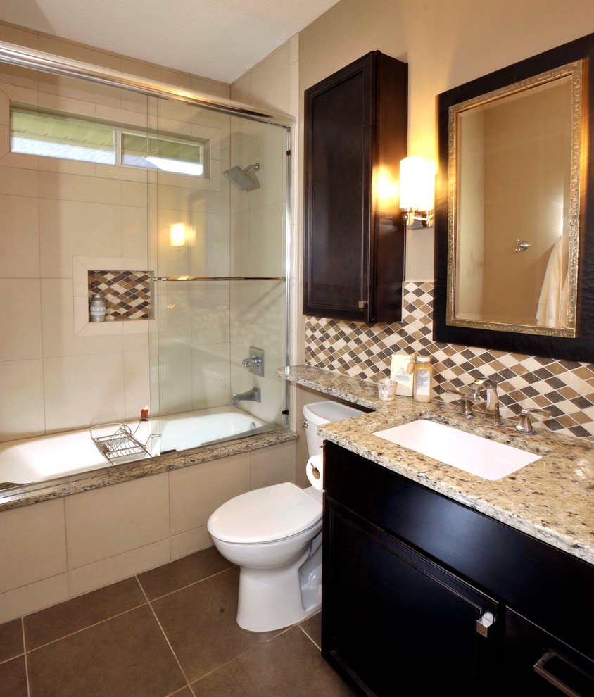 Photo of a mid-sized transitional kids bathroom in Miami with an undermount sink, dark wood cabinets, quartzite benchtops, a shower/bathtub combo, a two-piece toilet, beige tile, beige walls and porcelain floors.