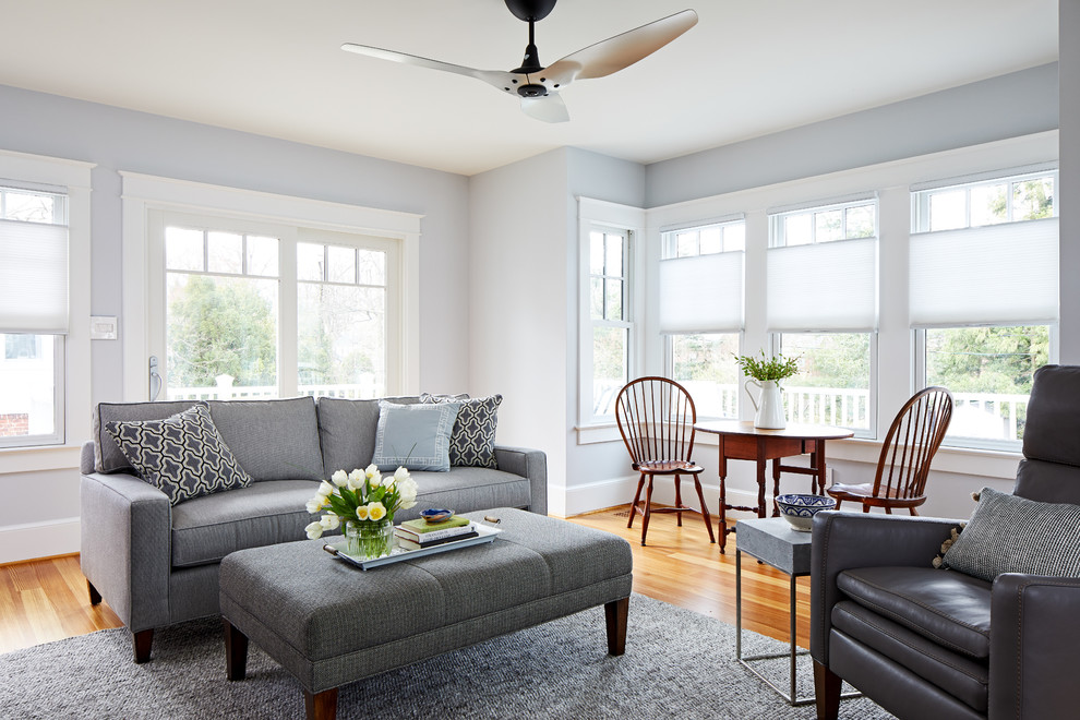 Mid-sized transitional enclosed medium tone wood floor family room photo in DC Metro with blue walls