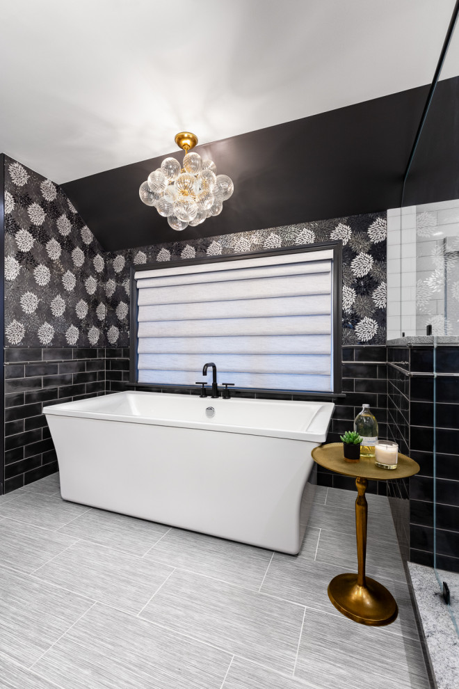 Inspiration for a mid-sized contemporary master bathroom in Detroit with a freestanding tub, a double shower, black and white tile, mosaic tile, grey walls, porcelain floors, grey floor, a hinged shower door and a shower seat.