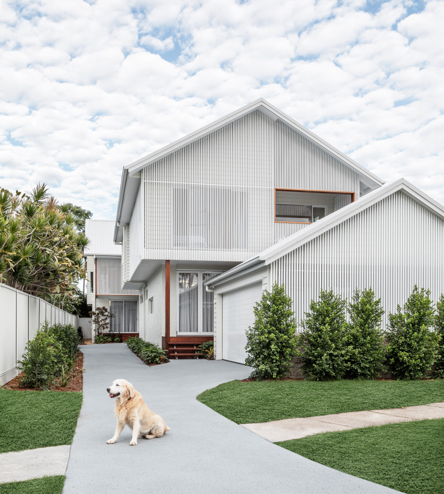 Beach style two-storey white duplex exterior in Other with metal siding and a gable roof.