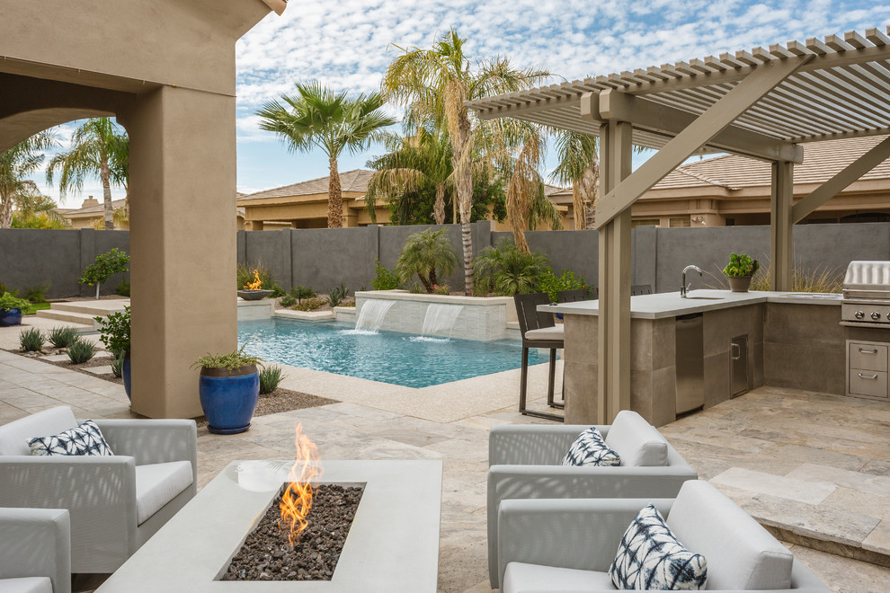 Design ideas for a contemporary backyard patio in Phoenix with an outdoor kitchen and a pergola.